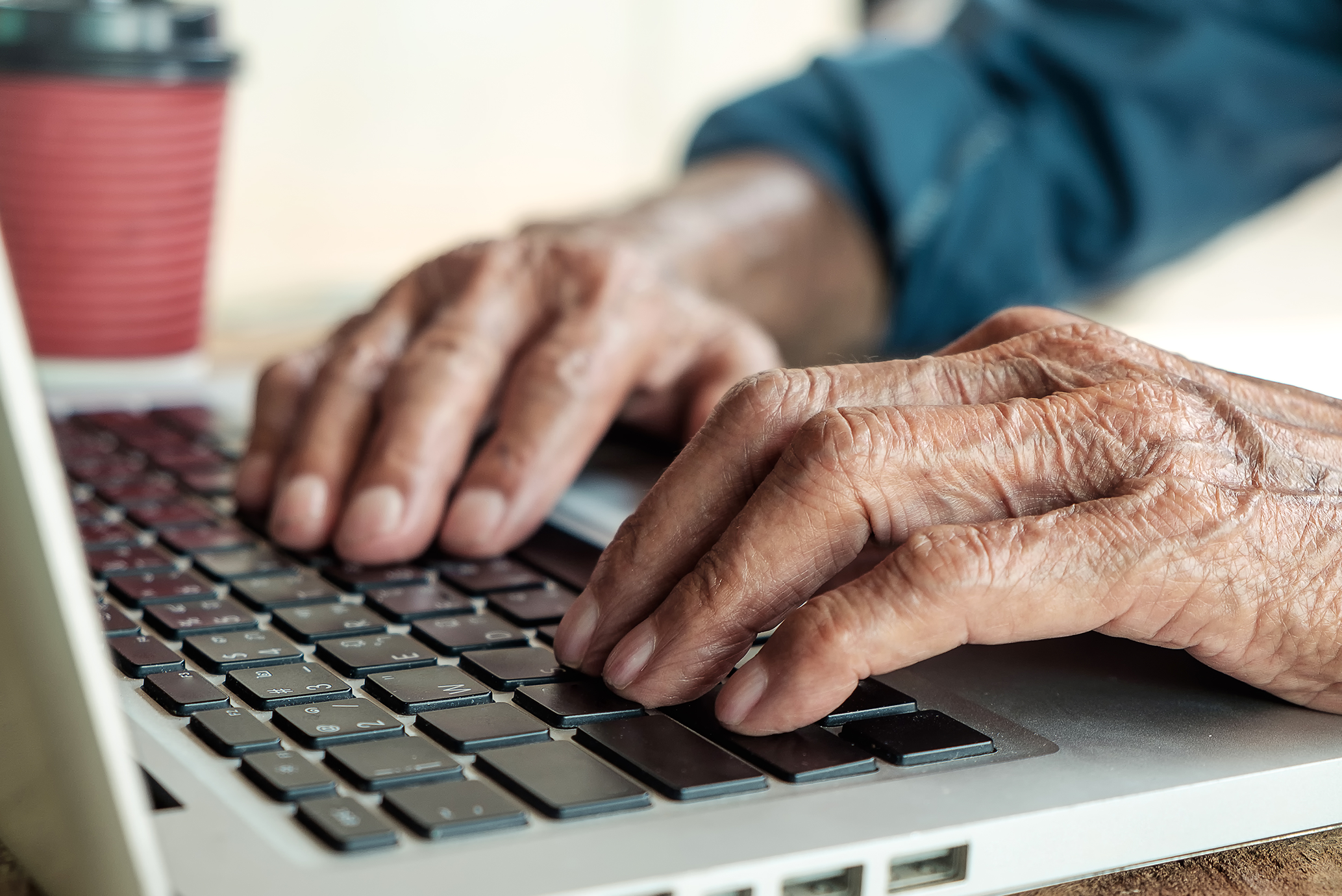 Elderly person using laptop