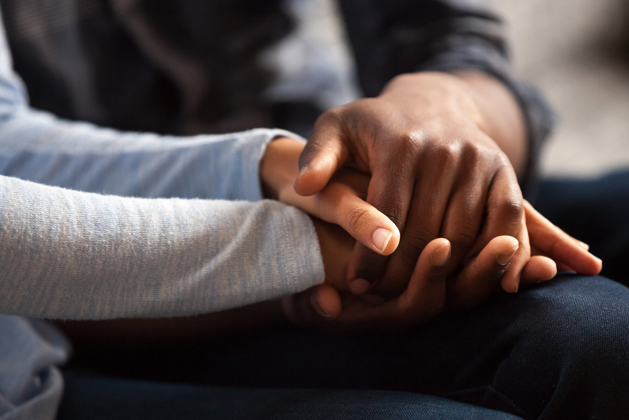 Two people holding hands